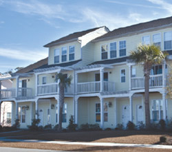 a photo of Whitney Lake's townhomes as seen across the lake